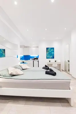 a large white bedroom with a large white bed at HeKo Collection Athens 2 in Athens