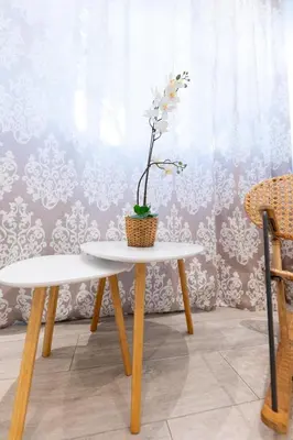 a white table with a flower in a basket on it at HeKo Collection Athens 2 in Athens