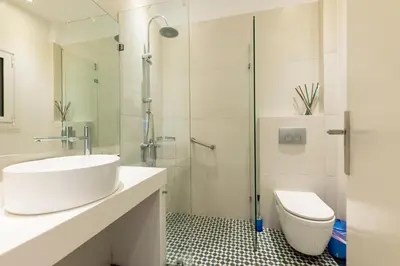 a white bathroom with a sink and a toilet at HeKo Collection Athens 2 in Athens