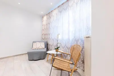 a room with a table and two chairs and a wall at HeKo Collection Athens 2 in Athens