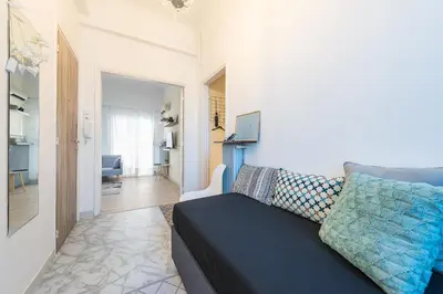 a living room with a black couch and a living room at Stylish 1BR Retreat in Central Athens in Athens