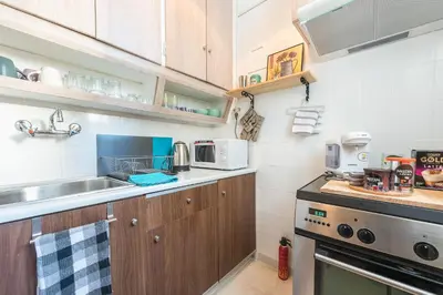 a kitchen with a sink and a stove at Stylish 1BR Retreat in Central Athens in Athens