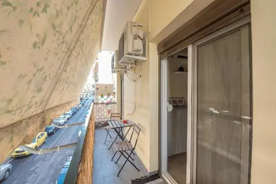a balcony with chairs and a view of a building at Stylish 1BR Retreat in Central Athens in Athens