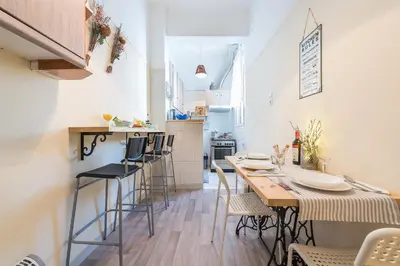 a kitchen and dining room with a table and chairs at Stylish 1BR Retreat in Central Athens in Athens