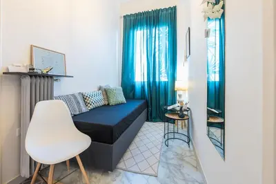 a living room with a black couch and a white chair at Stylish 1BR Retreat in Central Athens in Athens
