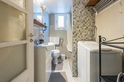 a small bathroom with a toilet and a sink at Stylish 1BR Retreat in Central Athens in Athens