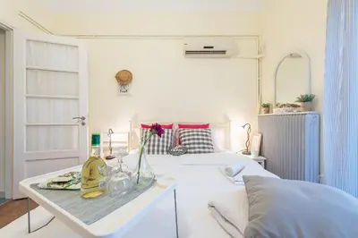 a white room with a bed and a table with a table sidx sidx at Stylish 1BR Retreat in Central Athens in Athens