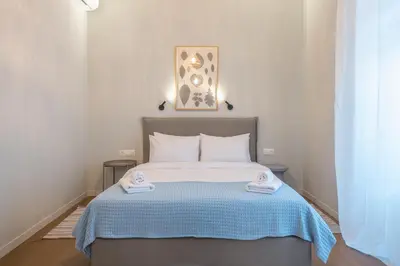 a bedroom with a bed with two towels on it at Zen Style, Exarchia in Athens