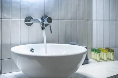 a white sink with water coming out of it at Zen Style, Exarchia in Athens