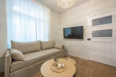 a living room with a couch and a table at Zen Style, Exarchia in Athens