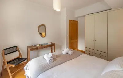 a bedroom with two white towels on a bed at Dream House Voula in Athens