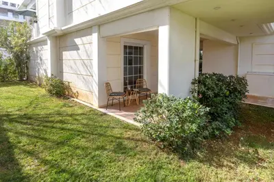 a porch of a house with a table and chairs at Dream House Voula in Athens