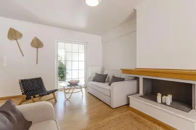 a living room with a couch and a fireplace at Dream House Voula in Athens