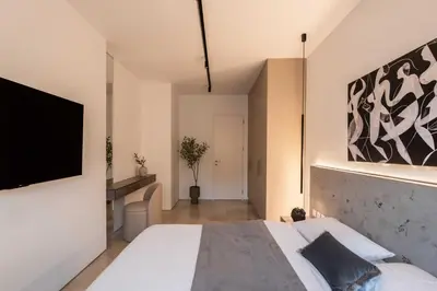 a bedroom with a large bed and a flat screen tv at ATELIER 57 , Stunning Acropolis View Monastiraki Apartment in Athens