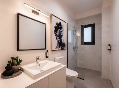 a white bathroom with a sink and a shower at ATELIER 57 , Stunning Acropolis View Monastiraki Apartment in Athens