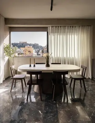 a dining room with a table and chairs and a window at ATELIER 57 , Stunning Acropolis View Monastiraki Apartment in Athens