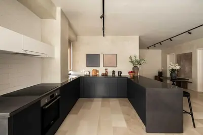 a kitchen with a black counter top in a room at ATELIER 57 , Stunning Acropolis View Monastiraki Apartment in Athens
