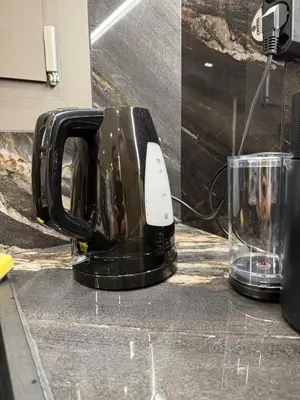a toaster sitting on a counter next to a glass at Plaza Luxury Suite, 2' from Metro, 5' from Piraeus in Piraeus