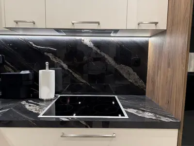 a kitchen with a black counter top with a stove at Plaza Luxury Suite, 2' from Metro, 5' from Piraeus in Piraeus