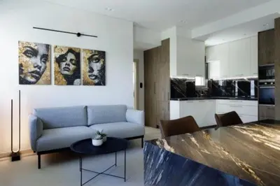 a living room with a couch and a table at Plaza Luxury Suite, 2' from Metro, 5' from Piraeus in Piraeus