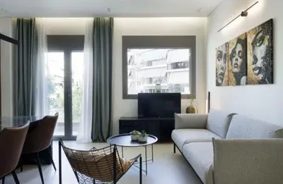 a living room with a couch and a table at Plaza Luxury Suite, 2' from Metro, 5' from Piraeus in Piraeus