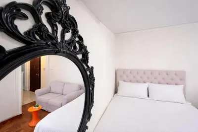 a bedroom with a mirror and a bed and a chair at Central Studio Near Uni & Parks - Zografou by ΜΡS in Athens