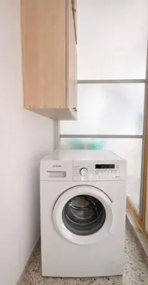 a washing machine with a wooden cabinet above it at Central Studio Near Uni & Parks - Zografou by ΜΡS in Athens