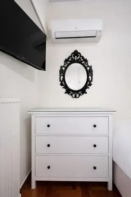 a bedroom with a white dresser and a mirror at Central Studio Near Uni & Parks - Zografou by ΜΡS in Athens