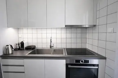 a kitchen with a stainless steel sink and white cabinets at Central Studio Near Uni & Parks - Zografou by ΜΡS in Athens