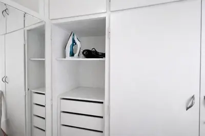 a closet with white walls and white cabinets at Central Studio Near Uni & Parks - Zografou by ΜΡS in Athens