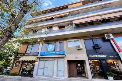 a building on a street next to a tree at Central Studio Near Uni & Parks - Zografou by ΜΡS in Athens