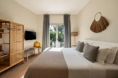 a bedroom with a large bed and a window at CALM South 19 in Athens