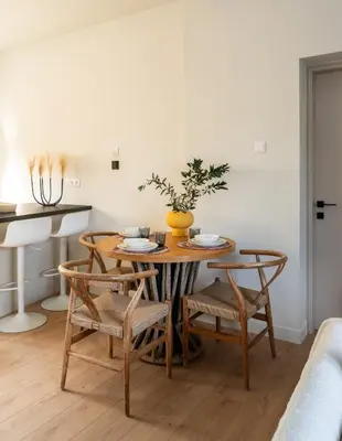 a dining room with a wooden table and chairs at CALM South 19 in Athens