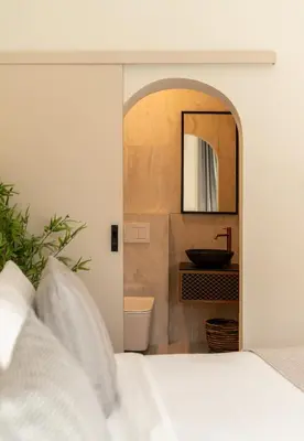 a bedroom with a bed and a sink and a mirror at CALM South 19 in Athens