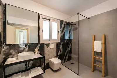 a bathroom with a sink and a toilet and a window at CALM South 19 in Athens