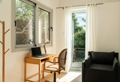 a room with a desk with a laptop and a chair at CALM South 19 in Athens