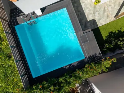 an overhead view of a swimming pool on the side of a house at Porto Blue Heaven in Porto Rafti