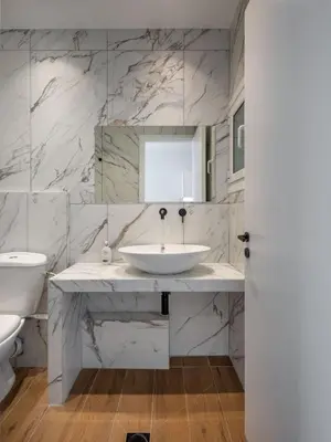 a white bathroom with a sink and a toilet at The White Apartment in Athens