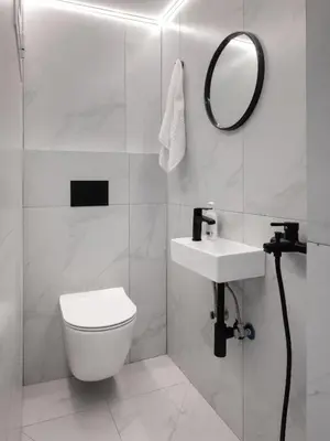 a white bathroom with a toilet and a mirror at The White Apartment in Athens