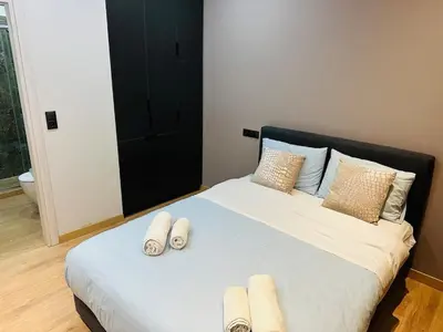 a bedroom with a bed with slippers on it at Agatha-4 in Piraeus