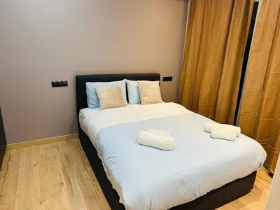 a bedroom with a bed with two towels on it at Agatha-4 in Piraeus