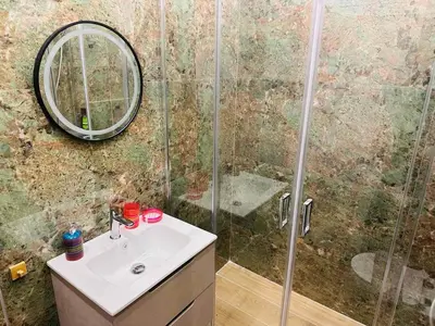 a bathroom with a shower and a sink and a mirror at Agatha-4 in Piraeus