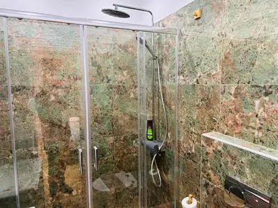 a shower with a glass door in a bathroom at Agatha-4 in Piraeus