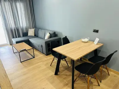 a living room with a table and a couch at Agatha-4 in Piraeus