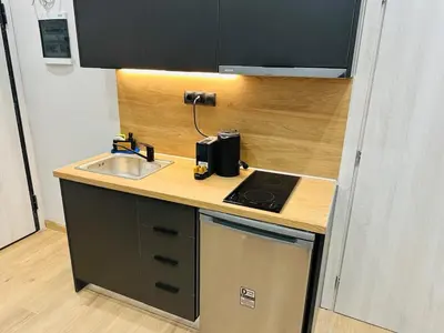 a small kitchen with a sink and a stove at Agatha-4 in Piraeus