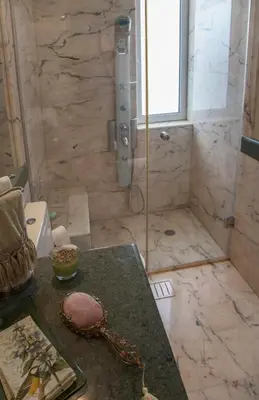 a bathroom with a shower with a glass door at Lagonisi Beach Villa in Lagonissi