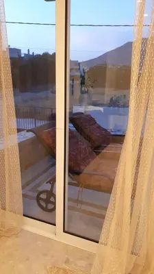 a window with a view of a view of a balcony at Lagonisi Beach Villa in Lagonissi