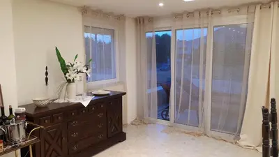 a kitchen with a dresser with flowers on it at Lagonisi Beach Villa in Lagonissi