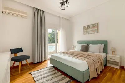 a bedroom with a large bed and a window at Sunlit 3BDR Family APT, Near Sea & City Center! in Athens