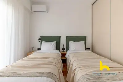 two beds sitting next to each other in a room at Sunlit Balcony Family APT Whirpool & Netflix in Athens